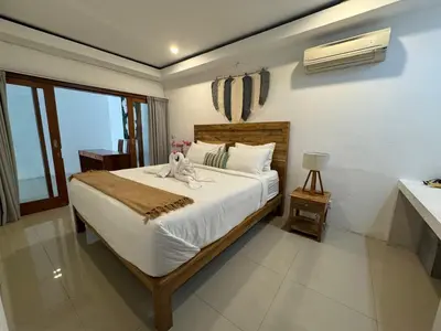 a bedroom with a bed with a stuffed animal on it at Villa Majegau 1 Seminyak in Seminyak