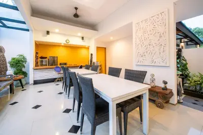 a dining room with a long table and chairs at Little Boutique Hotel 106- 30m from beach in Canggu