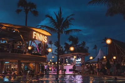 a pool at a theme park at night at Little Boutique Hotel 106- 30m from beach in Canggu