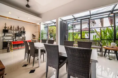 a dining room with a white table and chairs at Little Boutique Hotel 102 - 30m from beach in Canggu
