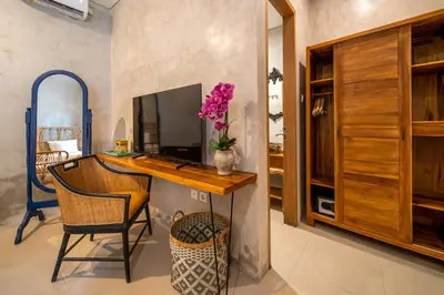 a home office with a desk and a television at Little Boutique Hotel 102 - 30m from beach in Canggu