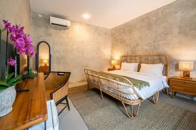 a bedroom with a bed and a table and a desk at Little Boutique Hotel 103- 30m from beach in Canggu