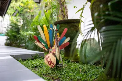 a group of colorful objects sitting in the grass at Little Boutique Hotel 107- 30m from beach in Canggu