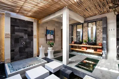 a lobby of a resort with sinks and toilets at Sunset Paradise Villa Nusa Dua in Nusa Dua