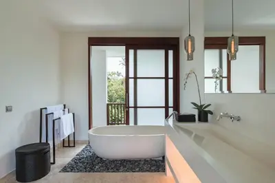 a bathroom with a white tub and a sink at Villa Amara Pradi - 550m to Petitenget Beach in Seminyak