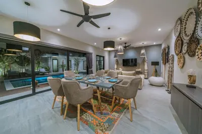 a dining room and living room with a table and chairs at Villa Batik - Brand New & Stylish 3BR Villa in Seminyak! in Seminyak