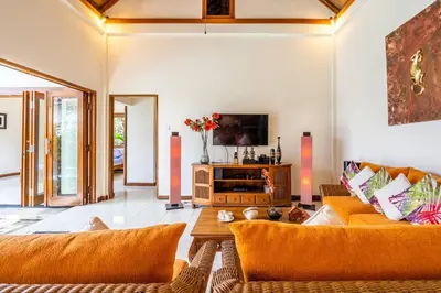 a living room with a couch and a tv at Taman Rahasia by iBali Management in Kerobokan