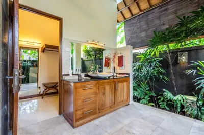 a bathroom with a sink and a mirror at Taman Rahasia by iBali Management in Kerobokan
