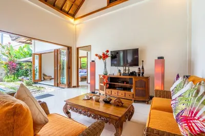 a living room with a couch and a table at Taman Rahasia by iBali Management in Kerobokan