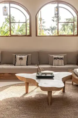 a living room with a couch and a coffee table at Villa Kanopi Luxurious 3BR Villa with Pool and Quick Beach Access in Canggu