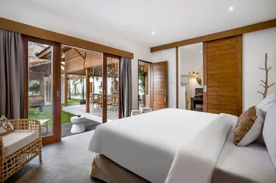 a bedroom with a white bed and a balcony at Villa Mimpi Seminyak by Alfred in Bali in Seminyak