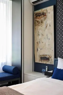 a bedroom with a bed and a painting on the wall at Adamare Villa Umalas in Kerobokan