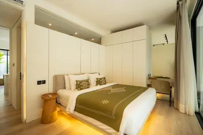 a bedroom with a large bed with white walls at Oasis Villa 8 by Betterplace in Canggu