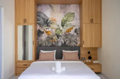 a bedroom with a bed with a stuffed animal on it at Villa Kamandari in Kuta