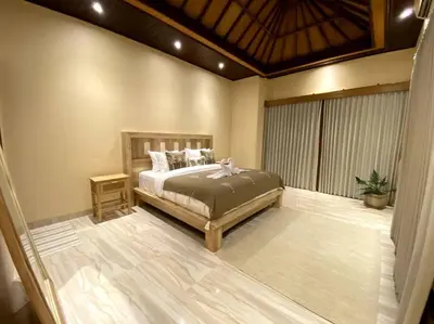 a bedroom with a bed and a window at Cozy 3 Bedroom Villa in Seminyak in Seminyak