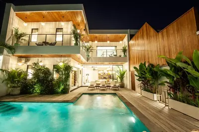 a house with a swimming pool in front of it at Zayana Villas Resort Seminyak in Seminyak