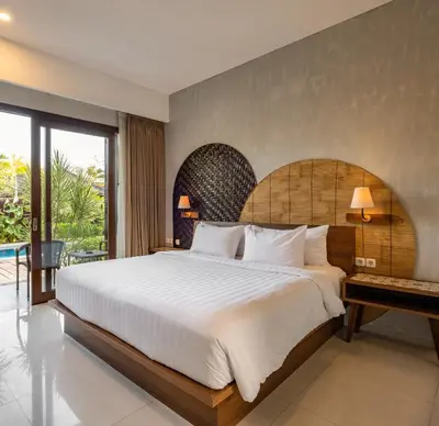 a bedroom with a large bed and a balcony at Cove Tevana in Seminyak