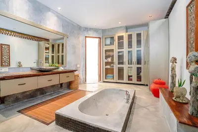 a large bathroom with a tub and a sink at Villa Elyse Seminyak in Seminyak