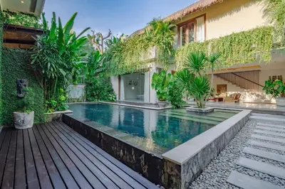 a swimming pool in the backyard of a house at Villa Elyse Seminyak in Seminyak