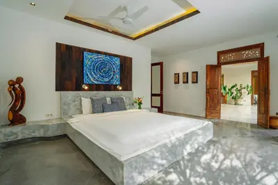 a large bedroom with a large bed and a painting on the wall at Villa Elyse Seminyak in Seminyak