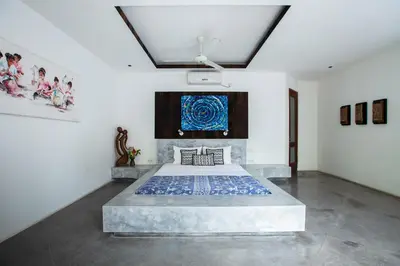 a bedroom with a large bed in a room at Villa Elyse Seminyak in Seminyak