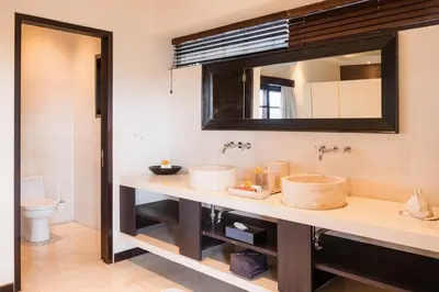 a bathroom with two sinks and a mirror at Villa Spirit 4 BR - Canggu in Canggu