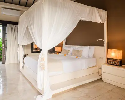 a bedroom with a bed with a canopy at Villa Spirit 4 BR - Canggu in Canggu