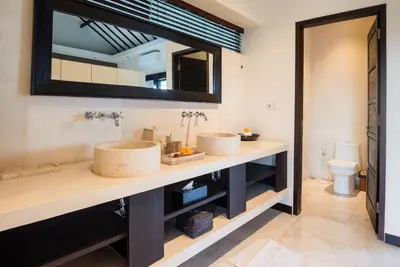 a bathroom with two sinks and a mirror at Villa Spirit 4 BR - Canggu in Canggu