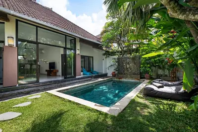 a swimming pool in the yard of a house at Saga Villas Oasis in Seminyak