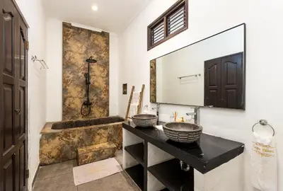 a bathroom with a sink and a tub at Saga Villas Oasis in Seminyak