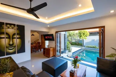 a living room with a view of a swimming pool at Vast 5bd Villa with Garden and Private Pool 250m to Beach in Seminyak