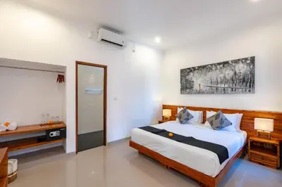 a bedroom with a large bed and a mirror at Vast 5bd Villa with Garden and Private Pool 250m to Beach in Seminyak