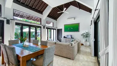 a dining room with a table and chairs at Cempaka Villa by Premier Hospitality Asia in Nusa Dua
