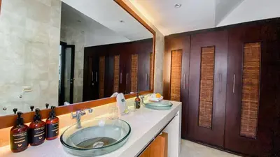 a bathroom with two sinks and a large mirror at Cempaka Villa by Premier Hospitality Asia in Nusa Dua