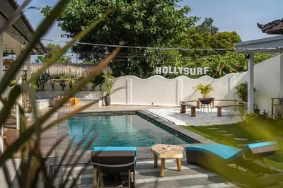 a swimming pool in a backyard with a table and chairs at SHAKA CLAN SURF in Canggu