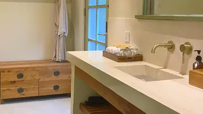 a bathroom with a sink and a mirror at White Penny Hostel in Seminyak