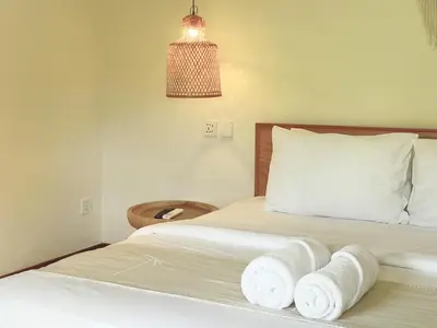 a bedroom with a bed with towels on it at White Penny Hostel in Seminyak