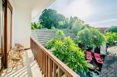 a balcony with a view of trees and plants at Villa Olli in Seminyak