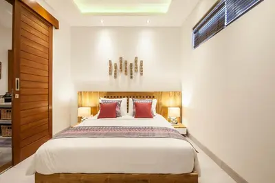 a bedroom with a large bed with red pillows at Luxurious 6 Br in Canggu 400m to Finns Beach in Canggu