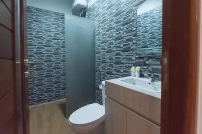 a bathroom with a white toilet and a sink at Vpas Villa in Seminyak