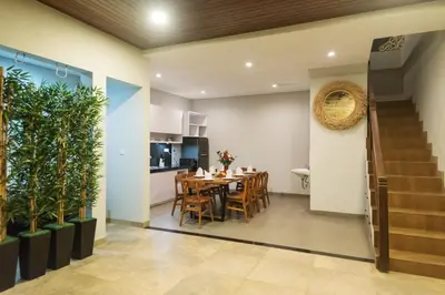 a dining room and kitchen with a table and chairs at Vpas Villa in Seminyak