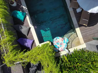 an overhead view of a swimming pool with an elephant toy at Tropical Beach House Bali in Seminyak