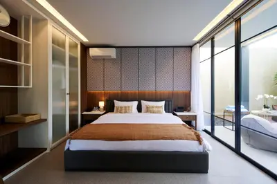 a bedroom with a large bed and a large window at New Luxury Villa Adamare 1 in Kerobokan