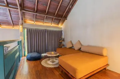 a living room with a couch and a table at The Reward Villas in Seminyak