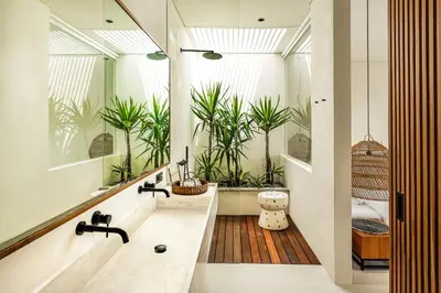 a bathroom with a large bath tub with plants at Casa Umalas Villa by Betterplace in Canggu