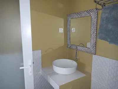 a bathroom with a sink and a mirror at 9 Residence's Seminyak in Seminyak
