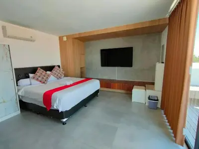 a bedroom with a bed and a flat screen tv at Milo Modern Five-Bedrooms Villa in Jimbaran