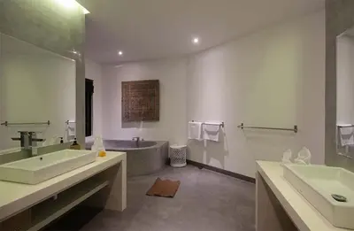 a bathroom with two sinks and a bath tub at Villa Papaya by Optimum Bali Villas in Canggu