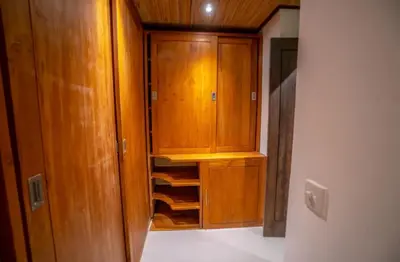 a closet with wooden cabinets in a room at Villa Jado 2 - 3 Bedroom Villa With Private Pool in Kerobokan
